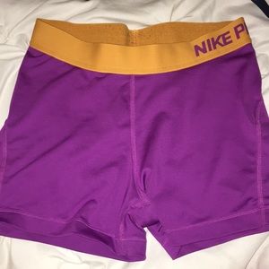 Purple and orange Nike pros
